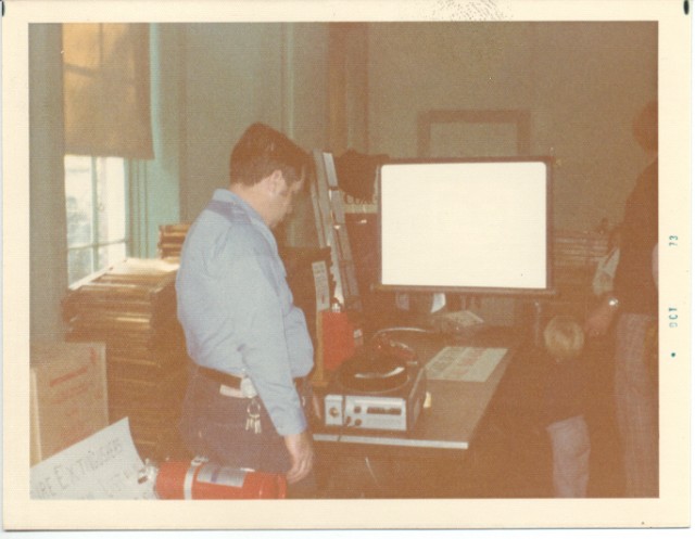 Jay Anderson operating a slide projector during an open house October 1973