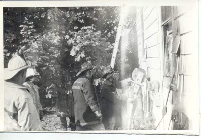 Asst. Chief Ed Stagner supervising Jack Stone (using saw) at the Spring Garden Hotel Fire.