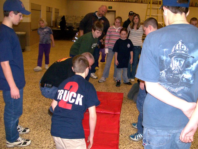 Making a Water Chute, 2008.  Cleaning up.  Folding the tarp properly.